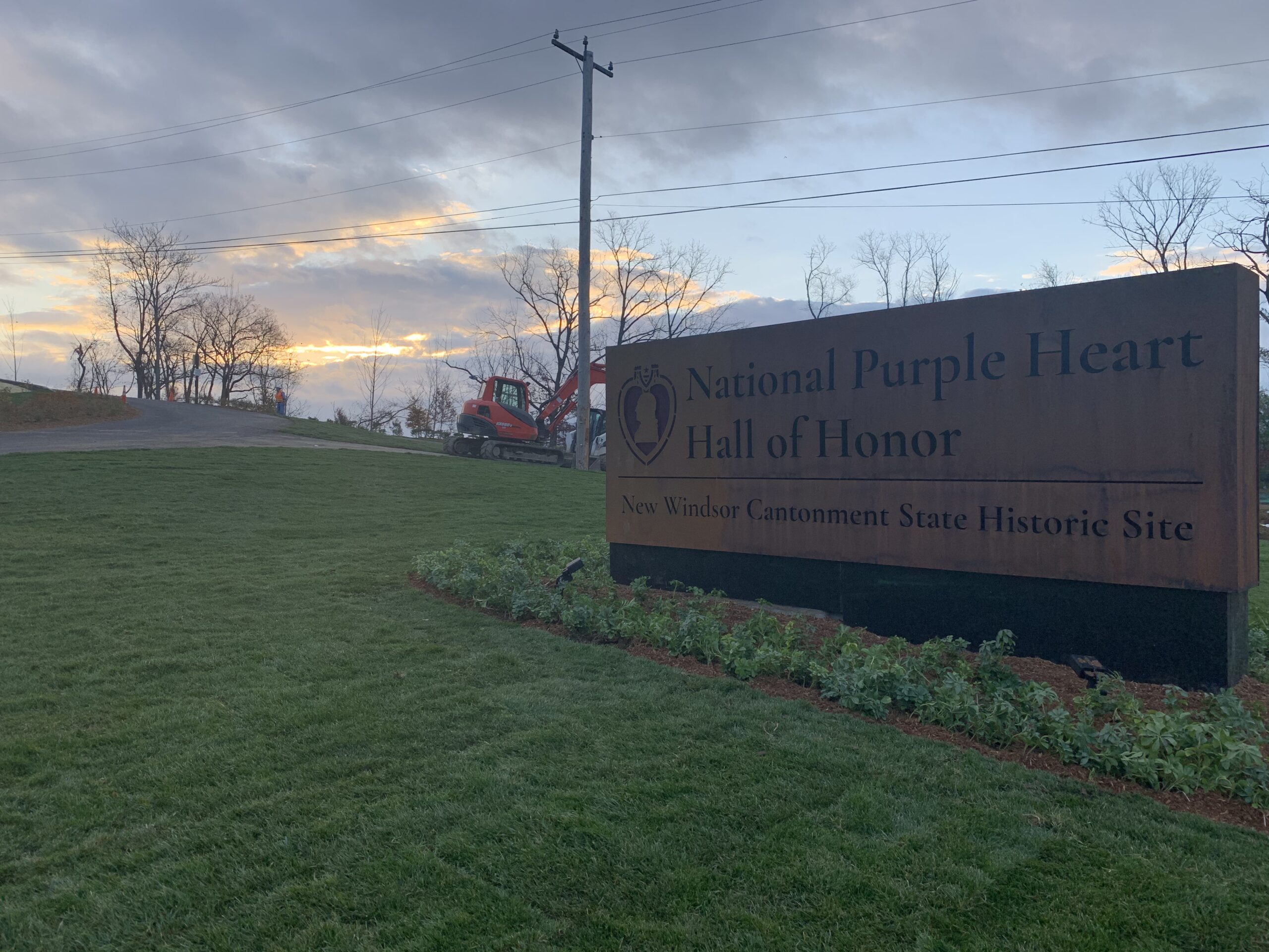 A sign for the National Purple Heart Hall of Honor with its brand information
